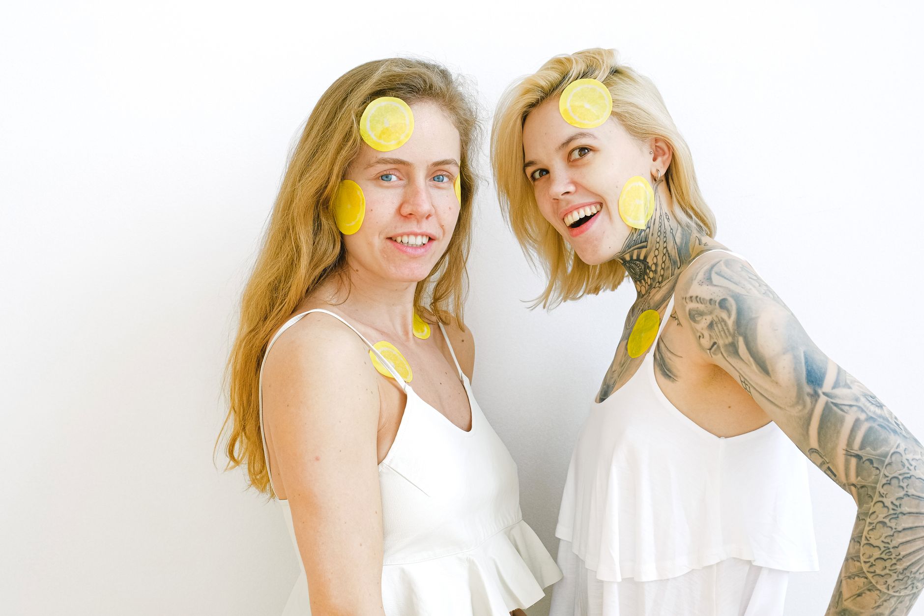 Vibrant collection of colorful sex toys arranged on a bright yellow surface