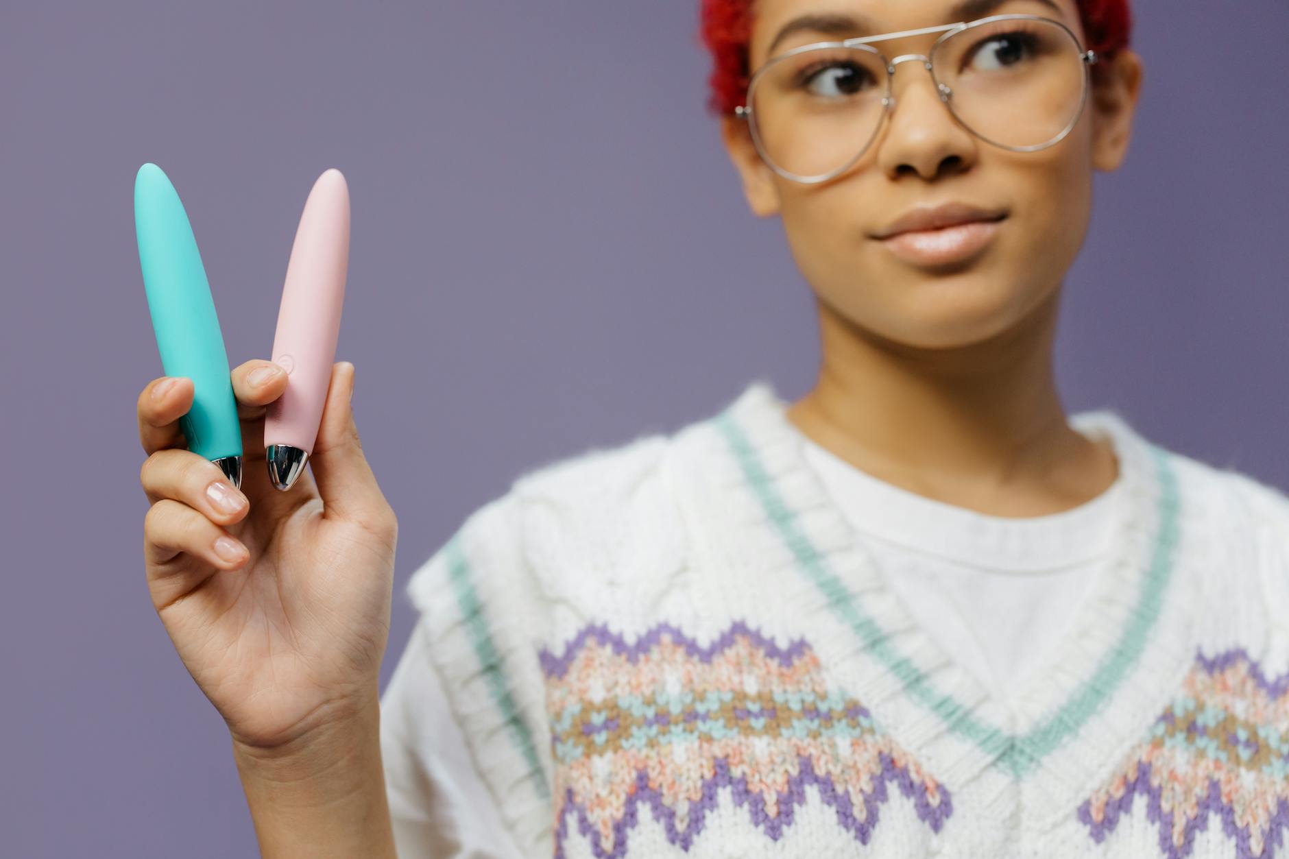 Colorful clitoral vibrators displayed on a purple background