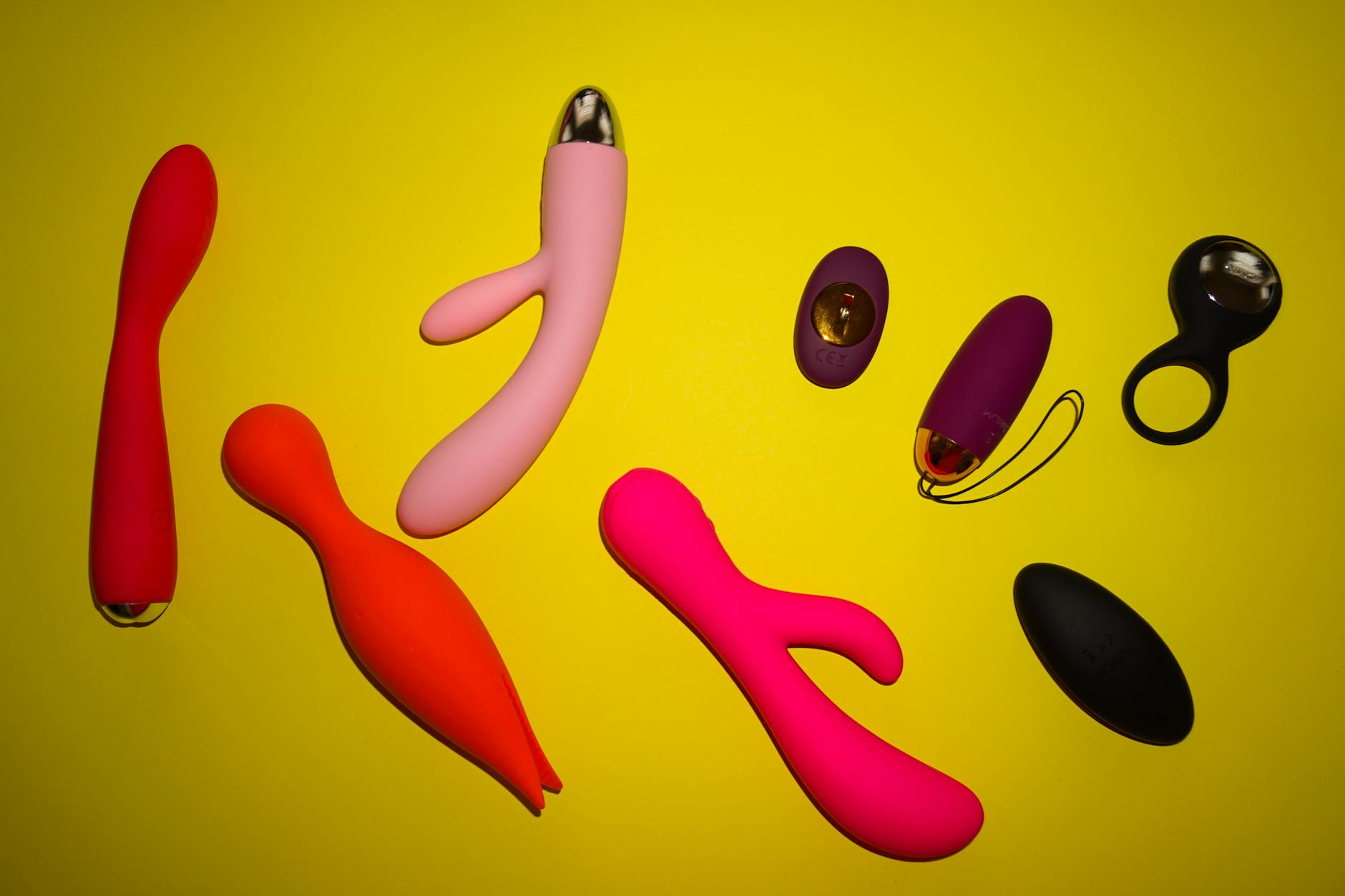 A lemon clitoral vibrator held in hand against a solid purple background, representing self-care and pleasure during wellness transitions